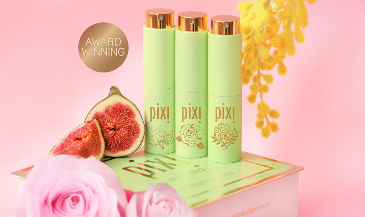 Award Winning: PixiPerfume Gift Trio shown on a pink background with plants
