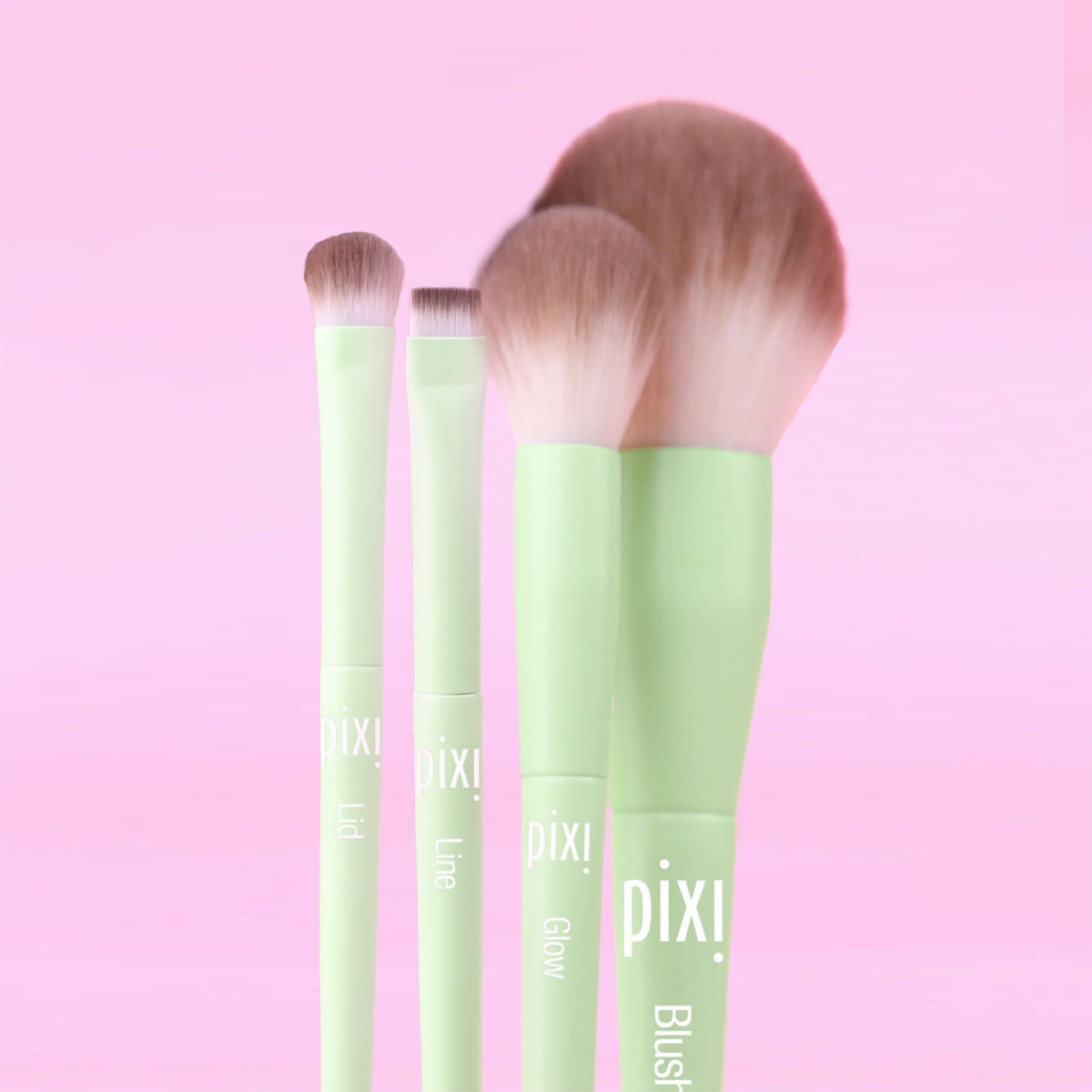Full Makeup Brush Collection featuring 4 brushes; Lid, Line, Glow and Blush, all on a pink background
