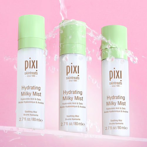 Three bottles of PIXI Hydrating Milky Mist on a pink background view 2