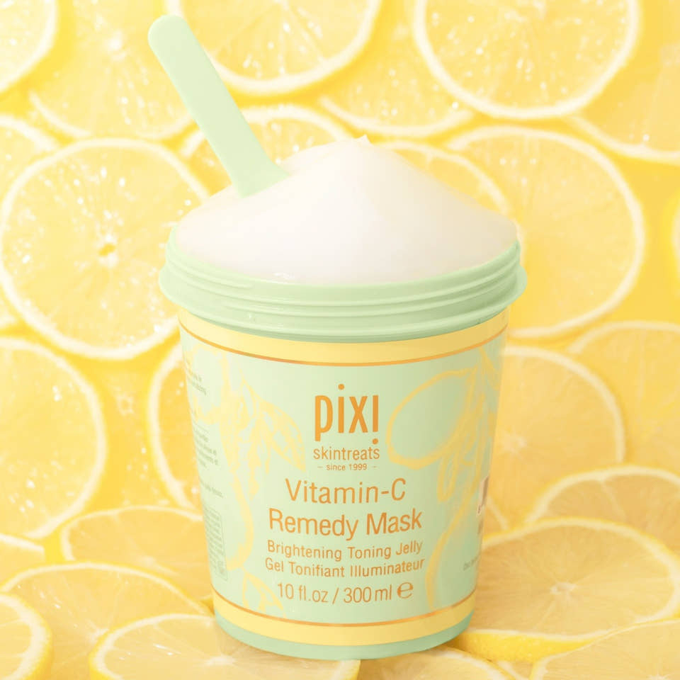 Vitamin-C Remedy Mask with lemon ingredients in the background. view 1