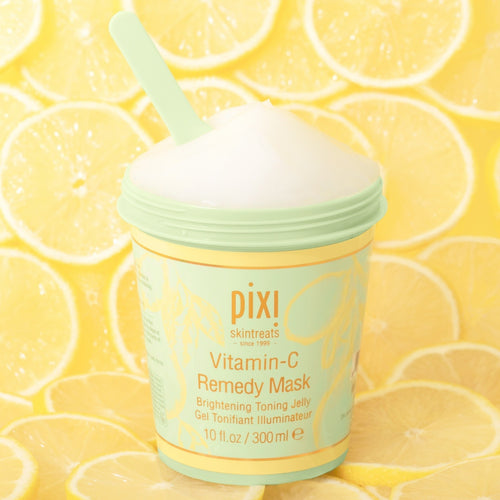 Vitamin-C Remedy Mask with lemon ingredients in the background. view 1