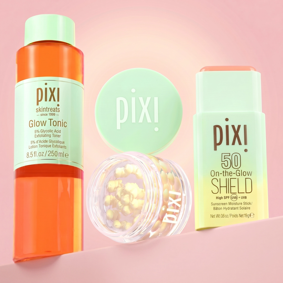 Pixi skincare products including Glow Tonic, On-the-Glow Shield SPF 50, and Vitamin-C CremeSerum on a pink background view 1